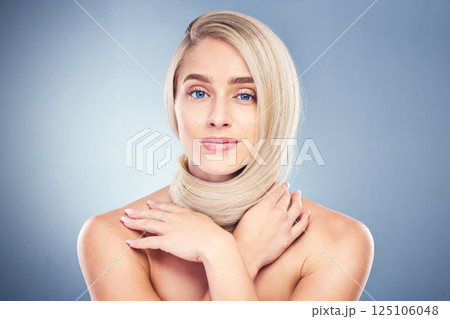 Beauty, hair and blonde with portrait of woman for shampoo, salon and health. Wellness, skincare and makeup with girl model for cosmetics, keratin and shine against a blue background in studio 125106048