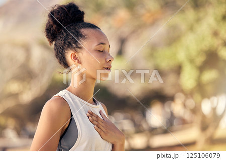 Black woman, breath and hand on chest, for meditation and wellness being peaceful to relax. Bokeh, African American female and lady outdoor, in nature and being calm for breathing exercise and health Black woman, breath and hand on chest, for meditation and wellness being peaceful to relax. Bokeh, African American female and lady outdoor, in nature and being calm for breathing exercise and health 125106079