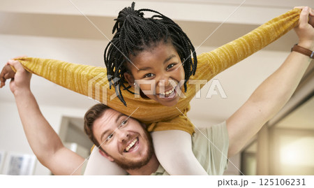 Happy father, adoption and smile for piggyback ride, playing or fun bonding relationship together at home. Dad carrying adopted kid on shoulders smiling for joyful family play time in the house 125106231