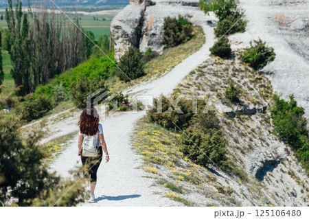 tourist climbing mountain on forest road tourist climbing mountain on forest road 125106480