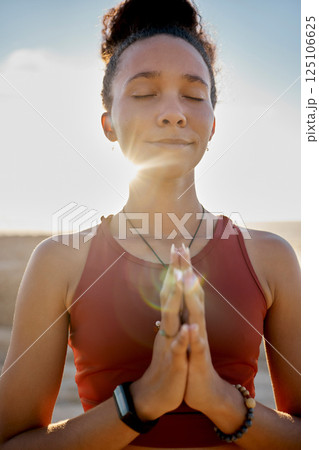 Yoga, pray hands and zen meditation or mental health in sunshine outdoors. Young woman relax, fitness and peace chakra or faith worship praying for balance, mindfulness and spiritual breathing 125106625
