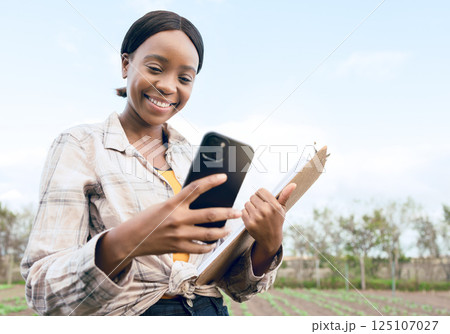 Agriculture, farm and woman with phone, clipboard and digital notes of ecology research or eco friendly farming. Sustainability field, agronomist farmer analysis or black girl study plantation growth Agriculture, farm and woman with phone, clipboard and digital notes of ecology research or eco friendly farming. Sustainability field, agronomist farmer analysis or black girl study plantation growth 125107027