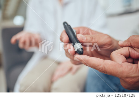 Finger, healthcare and diabetes with a senior man testing his blood sugar level while in his retirement home. Medical, wellness and test with a mature male using a glucometer to measure his glucose 125107129