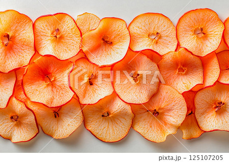 Colorful dried apple slices arranged artistically on a light background 125107205