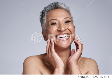 Elderly woman, smile and hands excited for beauty skincare or anti aging wellness in studio. Portrait of mature person, facial care and cosmetics makeup for natural skin glow against grey background Elderly woman, smile and hands excited for beauty skincare or anti aging wellness in studio. Portrait of mature person, facial care and cosmetics makeup for natural skin glow against grey background 125107401