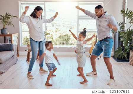 Family, dance and house for freedom and carefree fun bonding while being playful, silly and goofy. Playing, mother and father dancer and dancing with children, brother and sister in family home 125107611