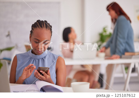 woman, phone and planning on laptop in office for digital marketing stratergy or finance budget report. Black woman, business communication app and writing email or fintech employee on smartphone 125107612