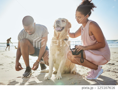 Fitness, couple and dog at beach, exercise and running on sand, ocean and summer workout, sports and healthy in sunshine. Strong man, woman and runner with labrador animal for cardio training at sea Fitness, couple and dog at beach, exercise and running on sand, ocean and summer workout, sports and healthy in sunshine. Strong man, woman and runner with labrador animal for cardio training at sea 125107616