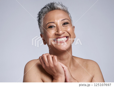 Skincare, beauty and senior dermatology with black woman in studio with smile, happiness and glow with cosmetic, makeup and facial product. Face portrait of mature model with healthy skin after botox Skincare, beauty and senior dermatology with black woman in studio with smile, happiness and glow with cosmetic, makeup and facial product. Face portrait of mature model with healthy skin after botox 125107697