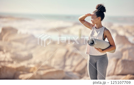Fitness exercise, yoga mat and black woman at beach preparing for workout outdoors with mockup. Zen, mindfulness meditation and happy female from South Africa ready for pilates training at seashore. 125107709
