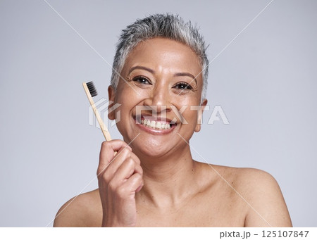 Dental, woman with toothbrush for hygiene with smile and grooming portrait, oral health and clean against studio background. Mature, dental care and whitening, fresh breath and healthy teeth mockup. Dental, woman with toothbrush for hygiene with smile and grooming portrait, oral health and clean against studio background. Mature, dental care and whitening, fresh breath and healthy teeth mockup. 125107847