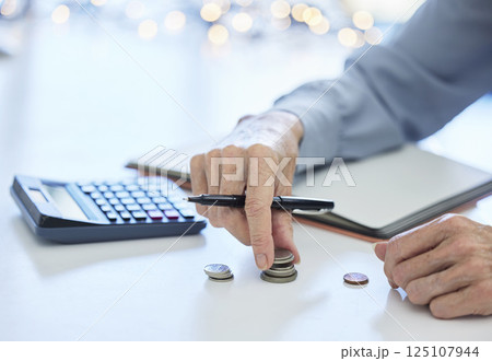 Budget, coin and business hands with calculator for inflation, savings and commerce financial planning. Money, cash and change for finance management, poverty and debt of bank balance or loan payment 125107944