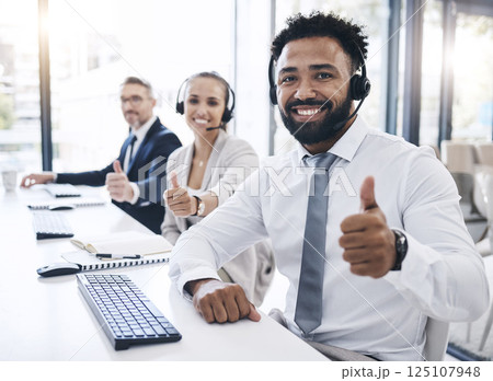 Thumbs up, call center staff and black man, success in the workplace, diversity and crm in customer service or telemarketing. Employee portrait, yes gesture and contact us, communication agreement. 125107948