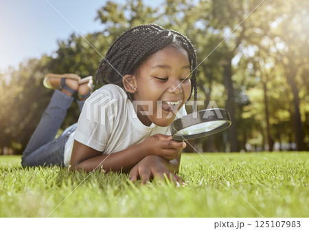 Learning, magnifier and child in nature for science knowledge, education and biology project discovery. Wow, ecology and field study with happy surprise of young black kid in South Africa park. 125107983
