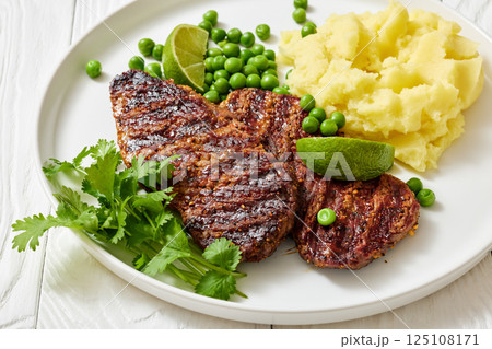 grilled beef cutlets with potato mash, green peas grilled beef cutlets with potato mash, green peas 125108171