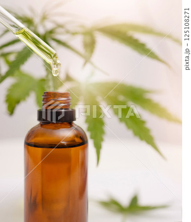 Cbd oil, hemp and cannabis leaf and dropper bottle for stress, healthcare and holistic use. Marijuana, 420 and weed plant leaf with liquid product for depression, anxiety and sleep production 125108271