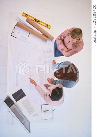Top view, teamwork and architects with blueprint in office for construction project from above. Meeting, architecture and development planning of contractors or engineers with building design sketch. Top view, teamwork and architects with blueprint in office for construction project from above. Meeting, architecture and development planning of contractors or engineers with building design sketch. 125108420