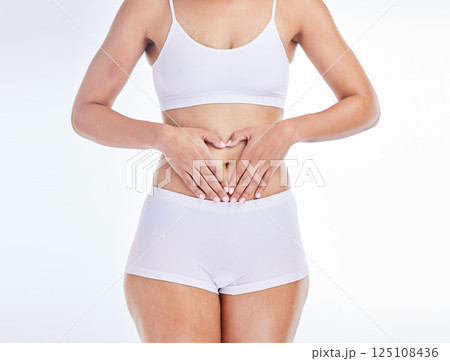 Health, heart and hands on woman stomach for training, nutrition and balance gut wellness. Menstruation, digestion and fitness with girl body for diet, probiotics or hair removal in white background 125108436
