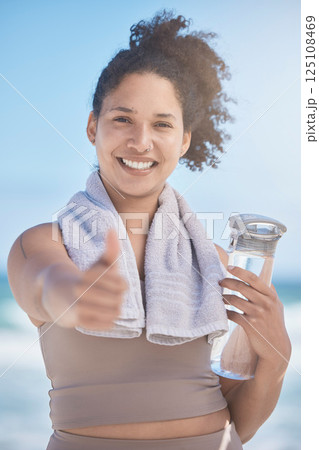 Thumbs up, water bottle and black woman in fitness, workout or training success, achievement and goal. Sports, runner girl on beach portrait with thank you, yes and like hand sign for healthy life Thumbs up, water bottle and black woman in fitness, workout or training success, achievement and goal. Sports, runner girl on beach portrait with thank you, yes and like hand sign for healthy life 125108469