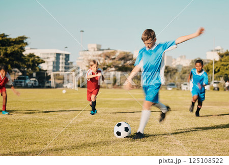 Soccer, boys running and kicking ball on field in summer, motivation and sports workout goals. Football, teamwork and growth, children playing game on grass soccer field in urban park with kids team. Soccer, boys running and kicking ball on field in summer, motivation and sports workout goals. Football, teamwork and growth, children playing game on grass soccer field in urban park with kids team. 125108522