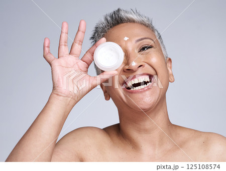 Mature woman, laughing and skincare cream in healthcare grooming, collagen glow wellness or facial dermatology routine. Smile, happy or beauty model with sunscreen product on Indian studio background Mature woman, laughing and skincare cream in healthcare grooming, collagen glow wellness or facial dermatology routine. Smile, happy or beauty model with sunscreen product on Indian studio background 125108574
