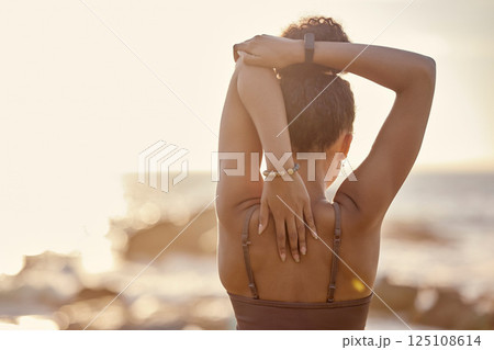 Black woman, stretching and back at beach, for training and exercise for wellness, health and fitness. Bokeh, African American girl and healthy female doing workout, healthy and flexibility in summer Black woman, stretching and back at beach, for training and exercise for wellness, health and fitness. Bokeh, African American girl and healthy female doing workout, healthy and flexibility in summer 125108614