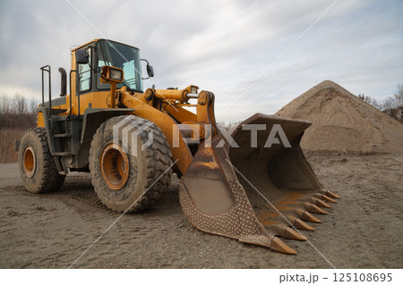 Heavy-Duty Yellow Loader with Large Shovel on Construction Site 125108695