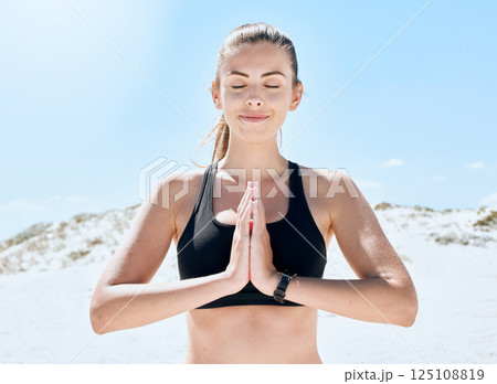 Yoga, meditation and beach fitness of a woman with zen, spiritual and calm exercise in nature. Health, training and meditate workout outdoor by the sea in summer for relax, peace and wellness 125108819