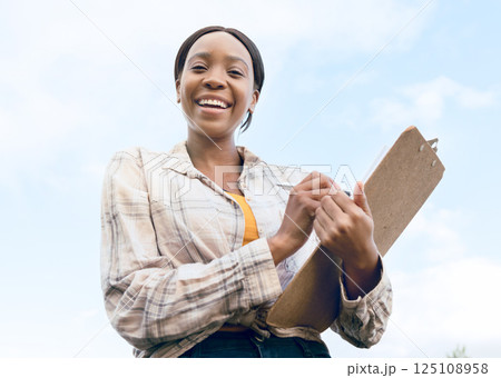 Farm, portrait and woman farmer with a checklist on a clipboard to monitor the growth of produce. Sustainable, agriculture and agro African girl working in a eco friendly environment on a field. Farm, portrait and woman farmer with a checklist on a clipboard to monitor the growth of produce. Sustainable, agriculture and agro African girl working in a eco friendly environment on a field. 125108958