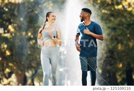 Diversity, running and couple wellness conversation in park for training exercise and sports marathon motivation. Interracial runner athletes, cardio workout and healthy fitness together in forest Diversity, running and couple wellness conversation in park for training exercise and sports marathon motivation. Interracial runner athletes, cardio workout and healthy fitness together in forest 125109110