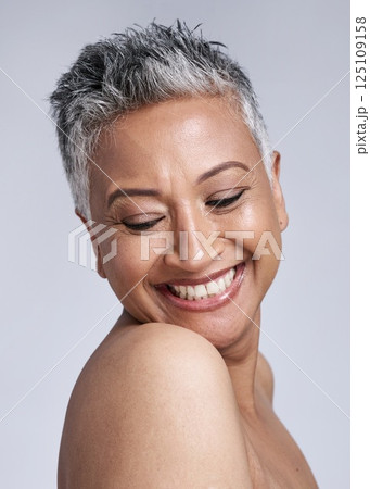 Face, beauty and skincare with a senior woman in studio on a gray background for wellness or natural care. Health, cosmetics and antiaging with a mature female posing for dermatology or cosmetology 125109158