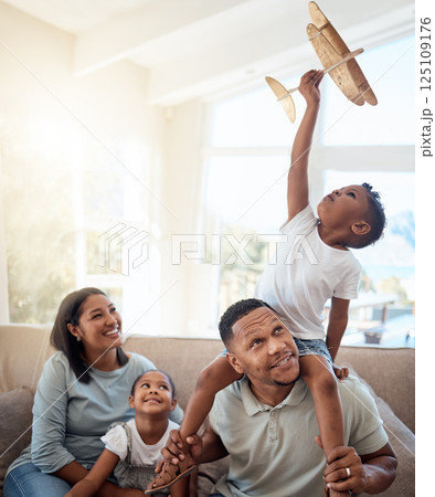Happy family playing living room with toy airplane for fun games, freedom and energy together in family home. Parents, kids and flying aeroplane toys to dream for travel, easy lifestyle and happiness 125109176