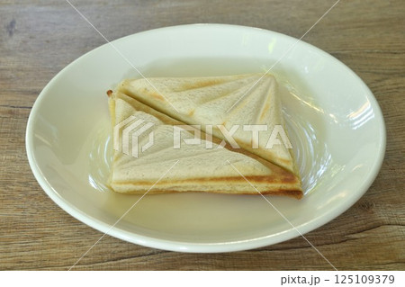 baking sandwich stuffing ham and cheese arraning on plate 125109379