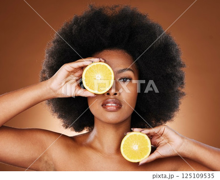 Lemon, black woman and vitamin c skincare, beauty and wellness, healthy food and detox, natural cosmetics and afro hair on studio background. Portrait, african and vegan model, citrus fruit and face Lemon, black woman and vitamin c skincare, beauty and wellness, healthy food and detox, natural cosmetics and afro hair on studio background. Portrait, african and vegan model, citrus fruit and face 125109535