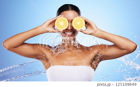 Black woman, water splash and orange skincare for natural beauty routine, organic skin health and vitamin c detox treatment. Happy smile, facial cleaning spa and advertising mockup on blue background Black woman, water splash and orange skincare for natural beauty routine, organic skin health and vitamin c detox treatment. Happy smile, facial cleaning spa and advertising mockup on blue background 125109649