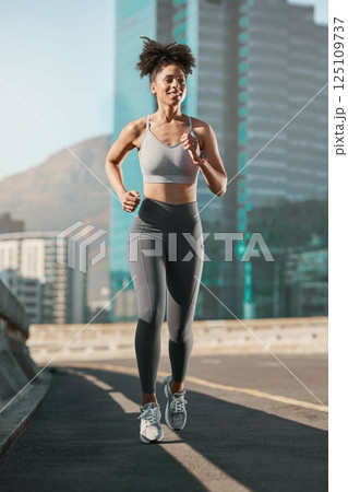 Running, fitness and city with a sports woman on a street for a cardio or endurance workout alone in the day. Health, training and exercise with a female athlete or runner on an asphalt road in town Running, fitness and city with a sports woman on a street for a cardio or endurance workout alone in the day. Health, training and exercise with a female athlete or runner on an asphalt road in town 125109737