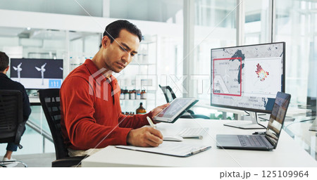 Computer screen, wind turbine and writing with business man in office for renewable energy or sustainability. Electricity, tablet and windmill with map on display for development or engineering Computer screen, wind turbine and writing with business man in office for renewable energy or sustainability. Electricity, tablet and windmill with map on display for development or engineering 125109964