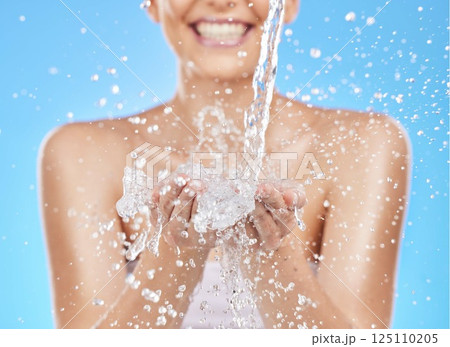 Skincare, hands and woman with splash of water for cleaning, washing and facial cleanse. Wellness, hydration and girl with liquid stream for luxury spa, beauty and hygiene in blue background studio Skincare, hands and woman with splash of water for cleaning, washing and facial cleanse. Wellness, hydration and girl with liquid stream for luxury spa, beauty and hygiene in blue background studio 125110205
