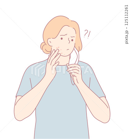 A concerned individual examining their skin with a look of uncertainty and anxiety 125112261