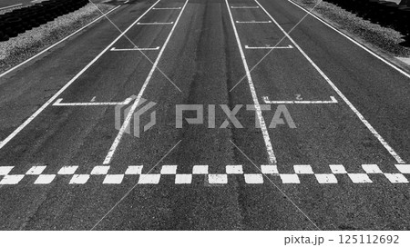 Start or finish line on car race, Start and finish line racing, Grid start race track, Top view textured and background grid start on the asphalt road race track abstract. Start or finish line on car race, Start and finish line racing, Grid start race track, Top view textured and background grid start on the asphalt road race track abstract. 125112692