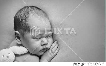 A newborn baby is wrapped in diapers with a wool cap in a basket. Swaddling, maternity hospital, family, ivf, life planning, parenting. A mother's love for her child. Baby food. High quality photo 125112772