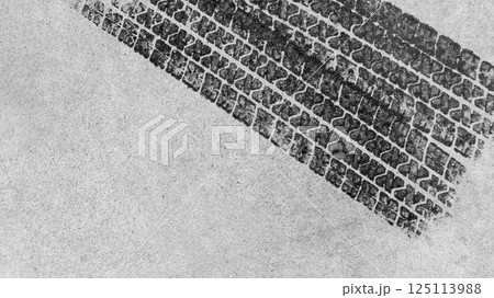 Top view tire marks on the asphalt road, Abstract texture and background black tire tracks on asphalt road, Tire marks on race track texture and background, Vehicle trace on road tire print texture of 125113988