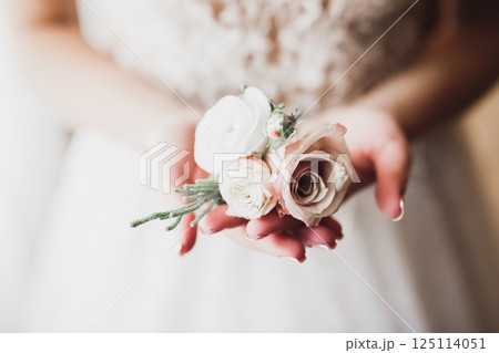 Bride holding big and beautiful wedding bouquet with flowers 125114051