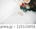 Two golden wedding rings isolated background concept Two golden wedding rings isolated background concept 125114058
