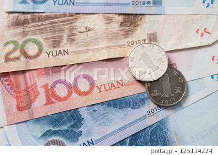 Many of different Chinese yuan banknotes. Chinese paper currency Yuan renminbi banknotes and coins as background. 125114224