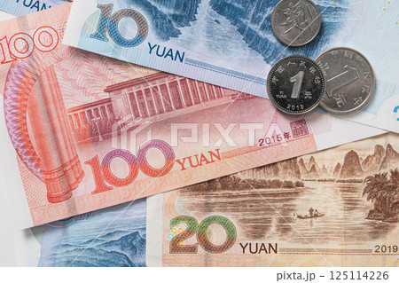 Many of different Chinese yuan banknotes. Chinese paper currency Yuan renminbi banknotes and coins as background. 125114226