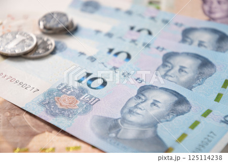 Many of different Chinese yuan banknotes. Chinese paper currency Yuan renminbi banknotes and coins as background. Many of different Chinese yuan banknotes. Chinese paper currency Yuan renminbi banknotes and coins as background. 125114238