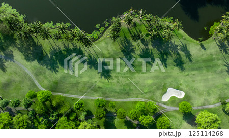 Top view golf course with lush greens, green fairway and sand bunker, Golf course green grass and trees fairway and putting green, Beautiful golf course. Top view golf course with lush greens, green fairway and sand bunker, Golf course green grass and trees fairway and putting green, Beautiful golf course. 125114268