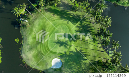 Top view golf course with lush greens, green fairway and sand bunker, Golf course green grass and trees fairway and putting green, Beautiful golf course. Top view golf course with lush greens, green fairway and sand bunker, Golf course green grass and trees fairway and putting green, Beautiful golf course. 125114269