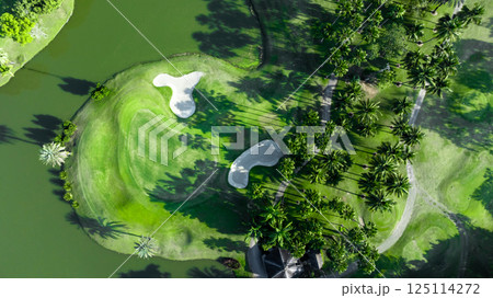 Top view golf course with lush greens, green fairway and sand bunker, Golf course green grass and trees fairway and putting green, Beautiful golf course. Top view golf course with lush greens, green fairway and sand bunker, Golf course green grass and trees fairway and putting green, Beautiful golf course. 125114272